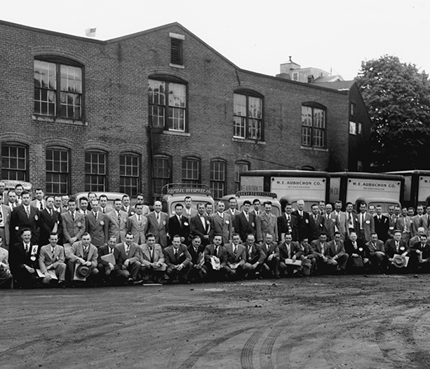 Aubuchon's entire workforce poses outside the original headquarters on 28 Rollstone Street in Fitchburg, MA also know as warehouse B.
