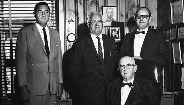 This picture taken in 1958 Standing from left to right are J. Paul Aubuchon; his father, John B. Aubuchon and William E. Aubuchon Jr. Sitting at the desk is William E. Aubuchon Sr.